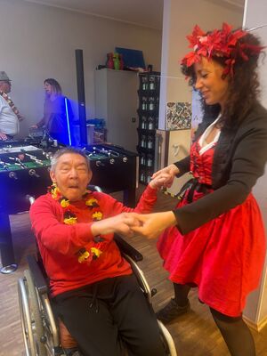 Ein Mann im Rollstuhl tanz mit einer Frau.