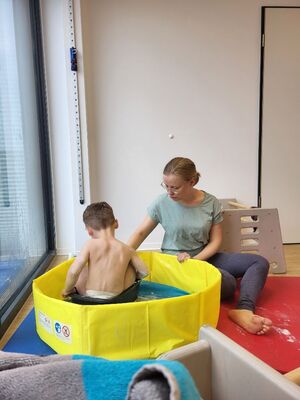 Eine Frau und ein Kind sitzen auf dem Boden.