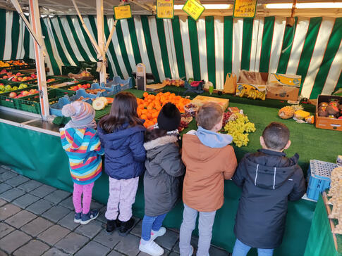 Ein paar Kinder am Gemüsestand