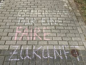 Mit Kreide wurde auf Steine geschrieben:Gemeinsam für eine faire Zukunft.