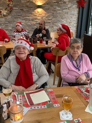 Zwei Personen sitzen am gedeckten Tisch.