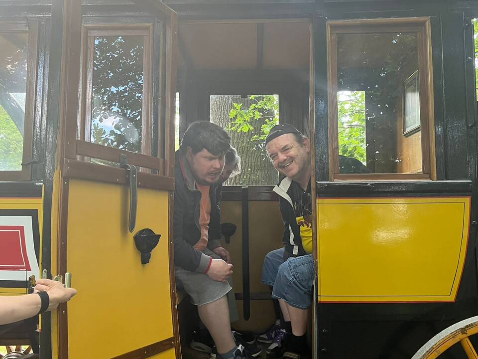 Zwei Personen sitzen in der Kutsche und schauen raus.