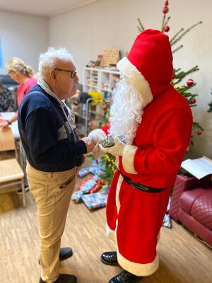 Der Nikolaus gibt einer Person die Hand.